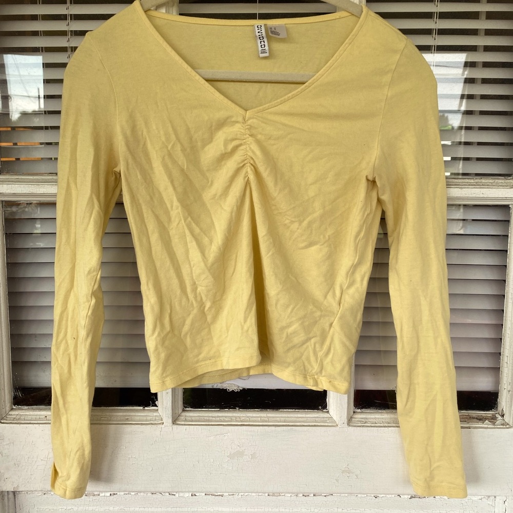 yellow tight long sleeve shirt with v neck